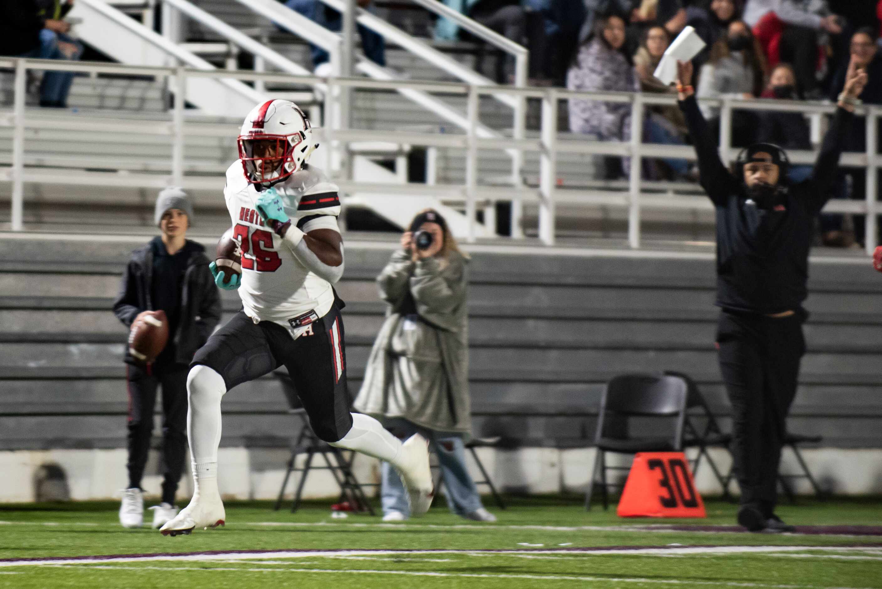 Heath senior Zach Evans (26) runs towards the end zone untouched to score a touchdown during...