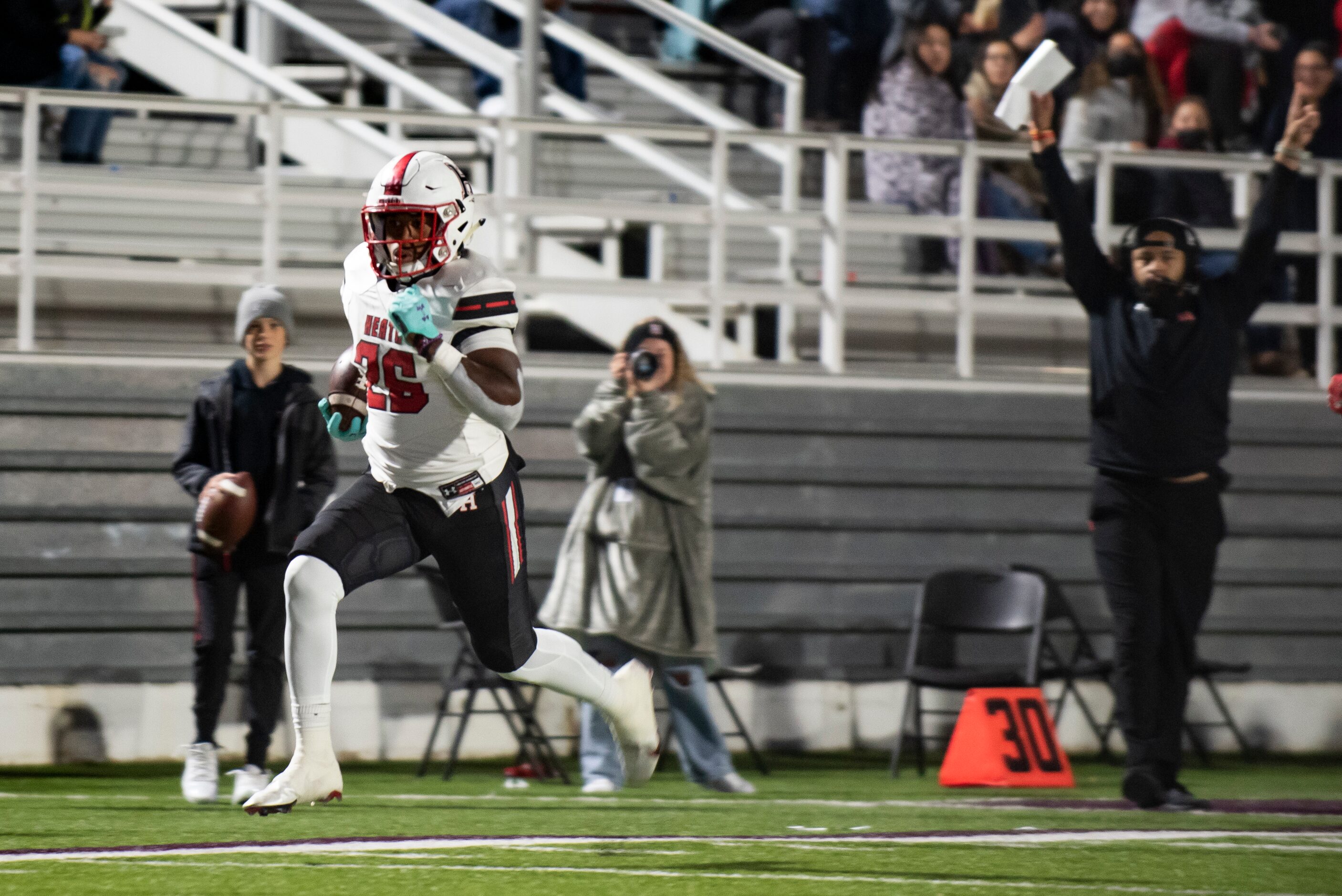 Heath senior Zach Evans (26) runs towards the end zone untouched to score a touchdown during...