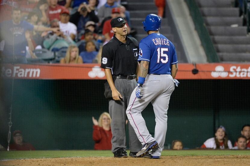 Jun 21, 2014; Anaheim, CA, USA; Texas Rangers left fielder Michael Choice (15) argues a...