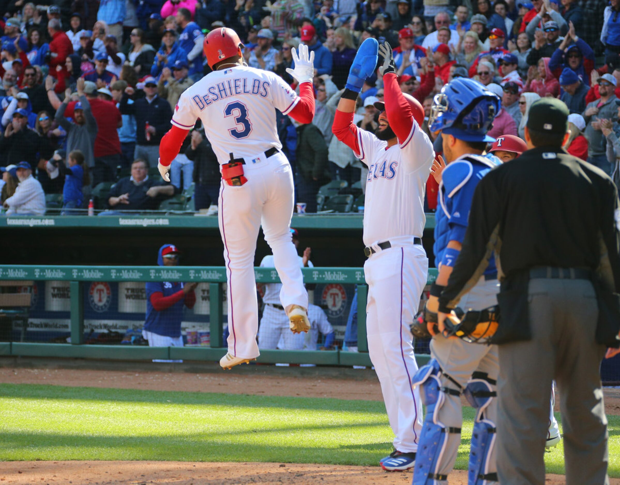 ARLINGTON, TX - MARCH 31: Nomar Mazara #30 of the Texas Rangers congratulates Delino...