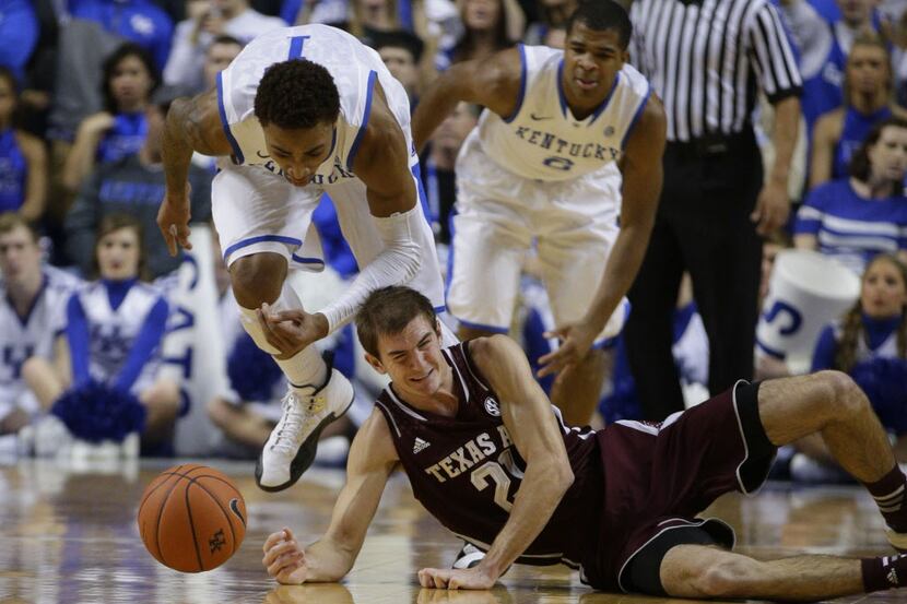Kentucky's James Young, left, steals the ball from Texas A&M's Alex Caruso (21) on Tuesday,...