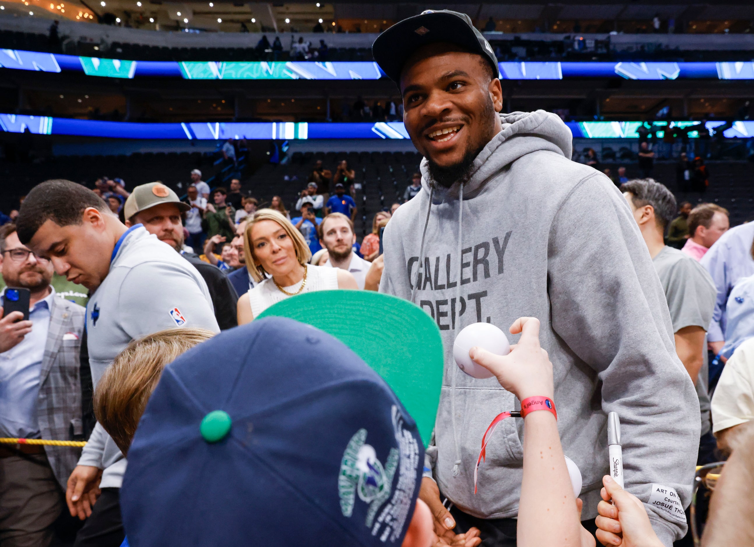 Dallas Cowboys linebacker Micah Parsons reacts towards the crowd while exiting an NBA...