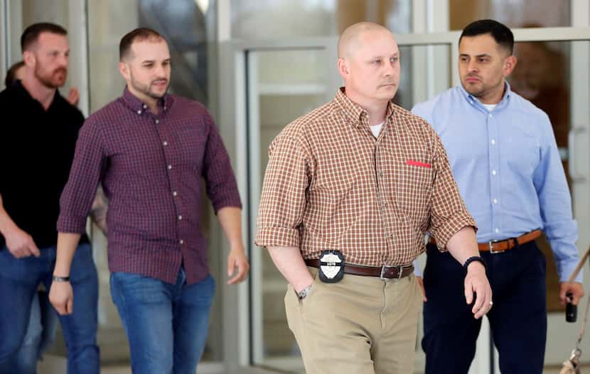 Fellow police officers of David Sherrard leave the Collin County Courthouse in McKinney...