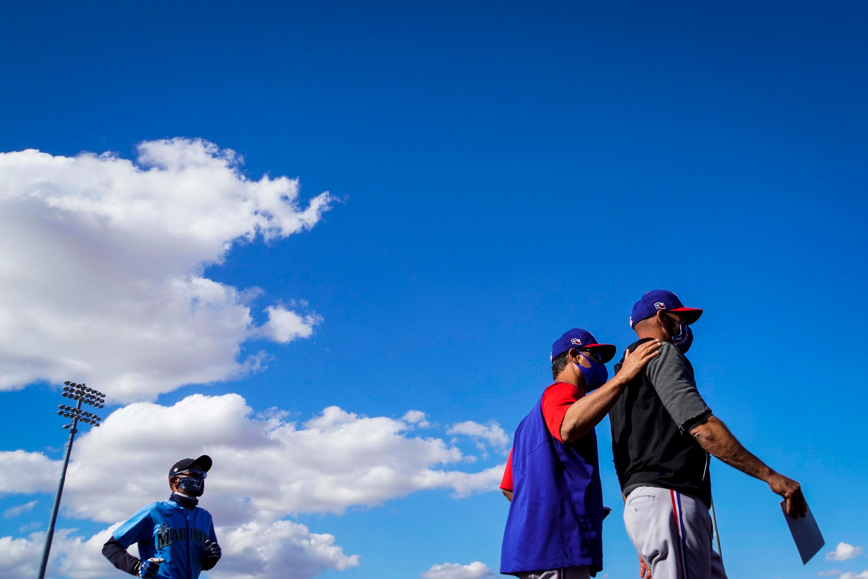 Texas Rangers manager Chris Woodward (right) leaves the field with bench coach Don Wakamatsu...