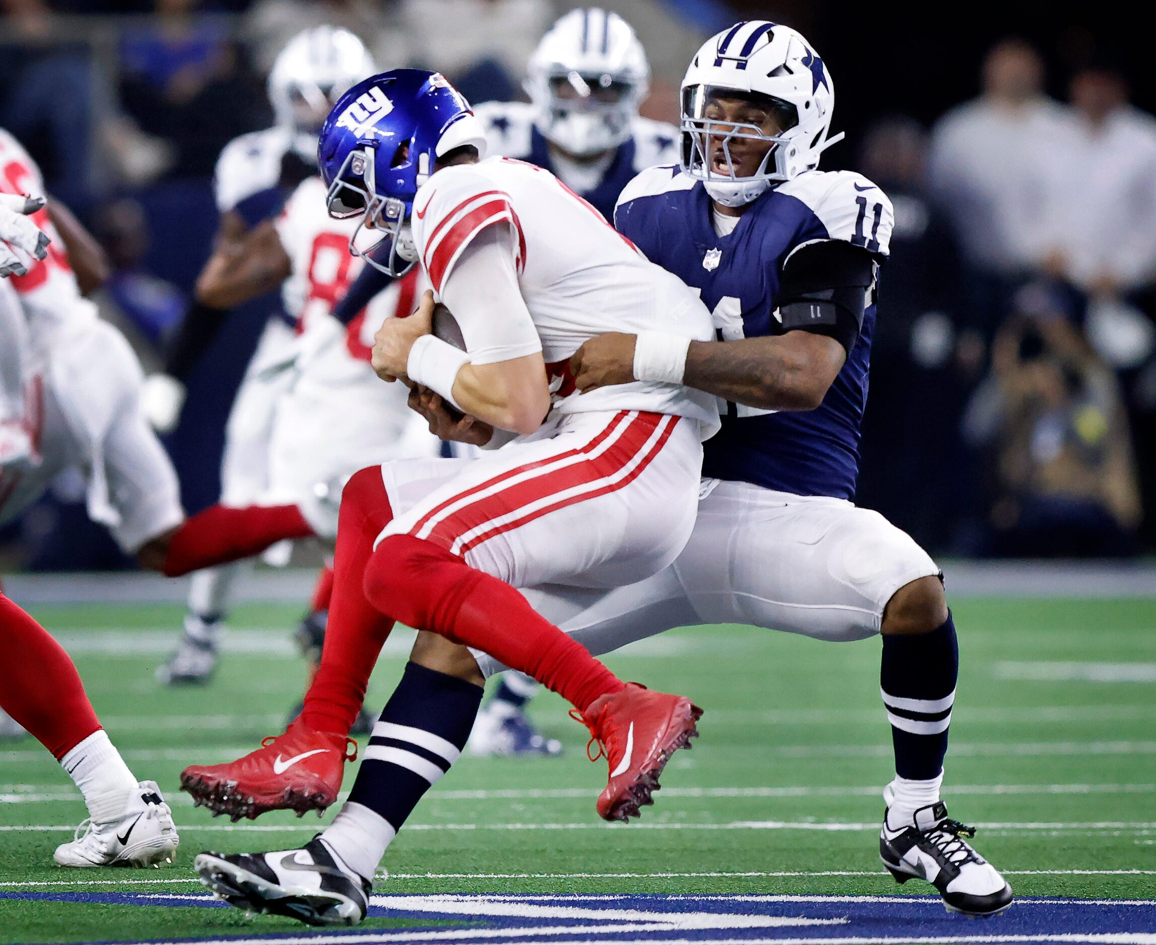 Dallas Cowboys linebacker Micah Parsons (11) makes a fourth quarter sack of New York Giants...