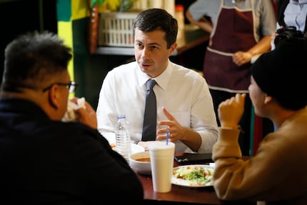 South Bend, Ind., Mayor Pete Buttigieg eats lunch with Iowa voters on Nov. 26, 2019, in...