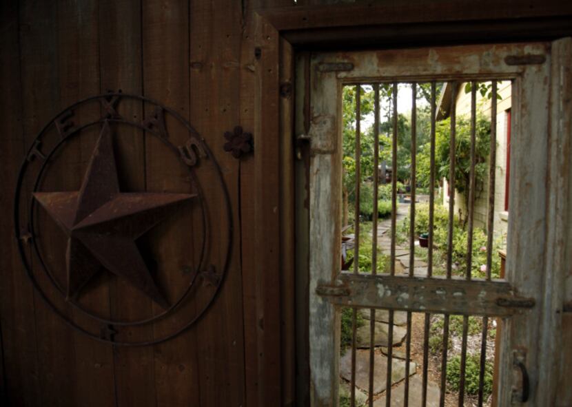 View of the front gate looking to the backyard of Suzy and Rob Renz's home in Dallas on...