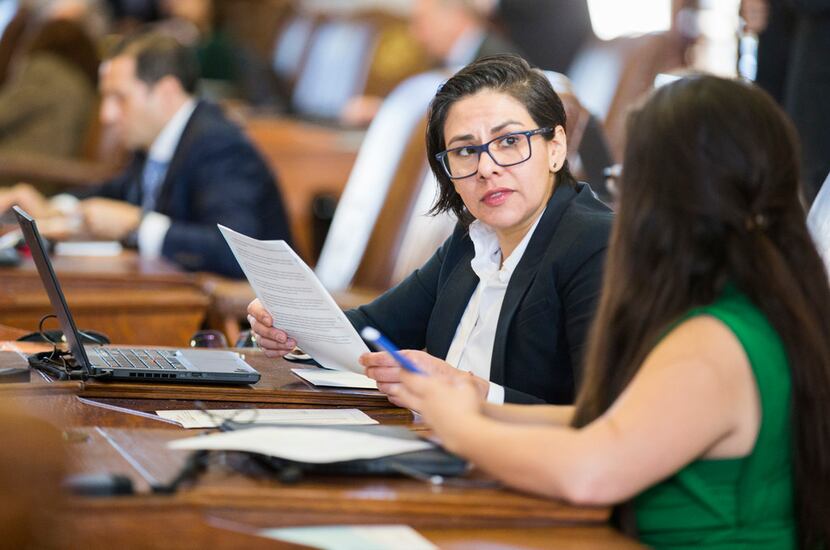 State Rep. Jessica Gonzalez talks with state Rep. Mary Gonzalez on Jan. 9, the second day of...