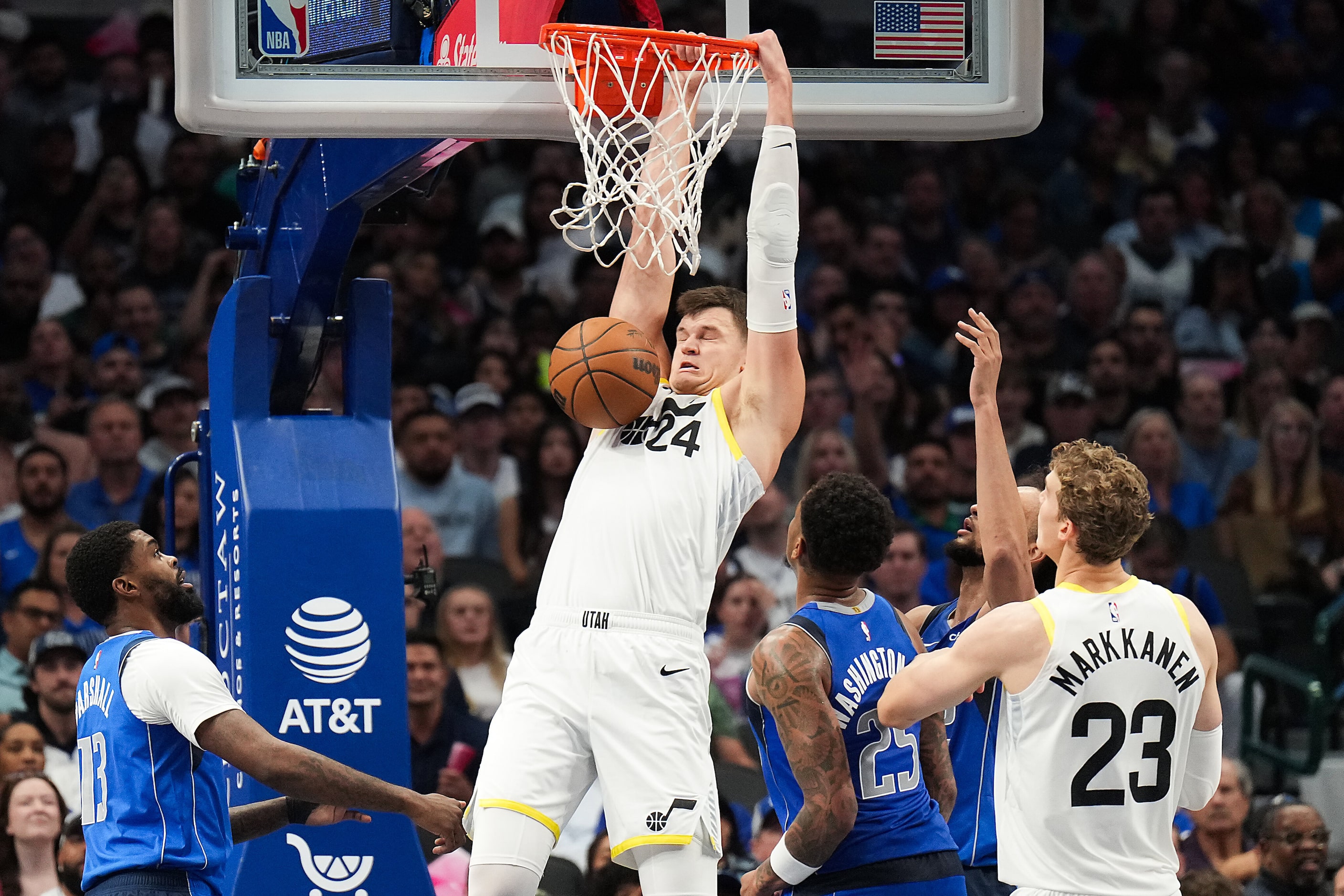 Utah Jazz center Walker Kessler (24) dunks past Dallas Mavericks forward Naji Marshall (13)...