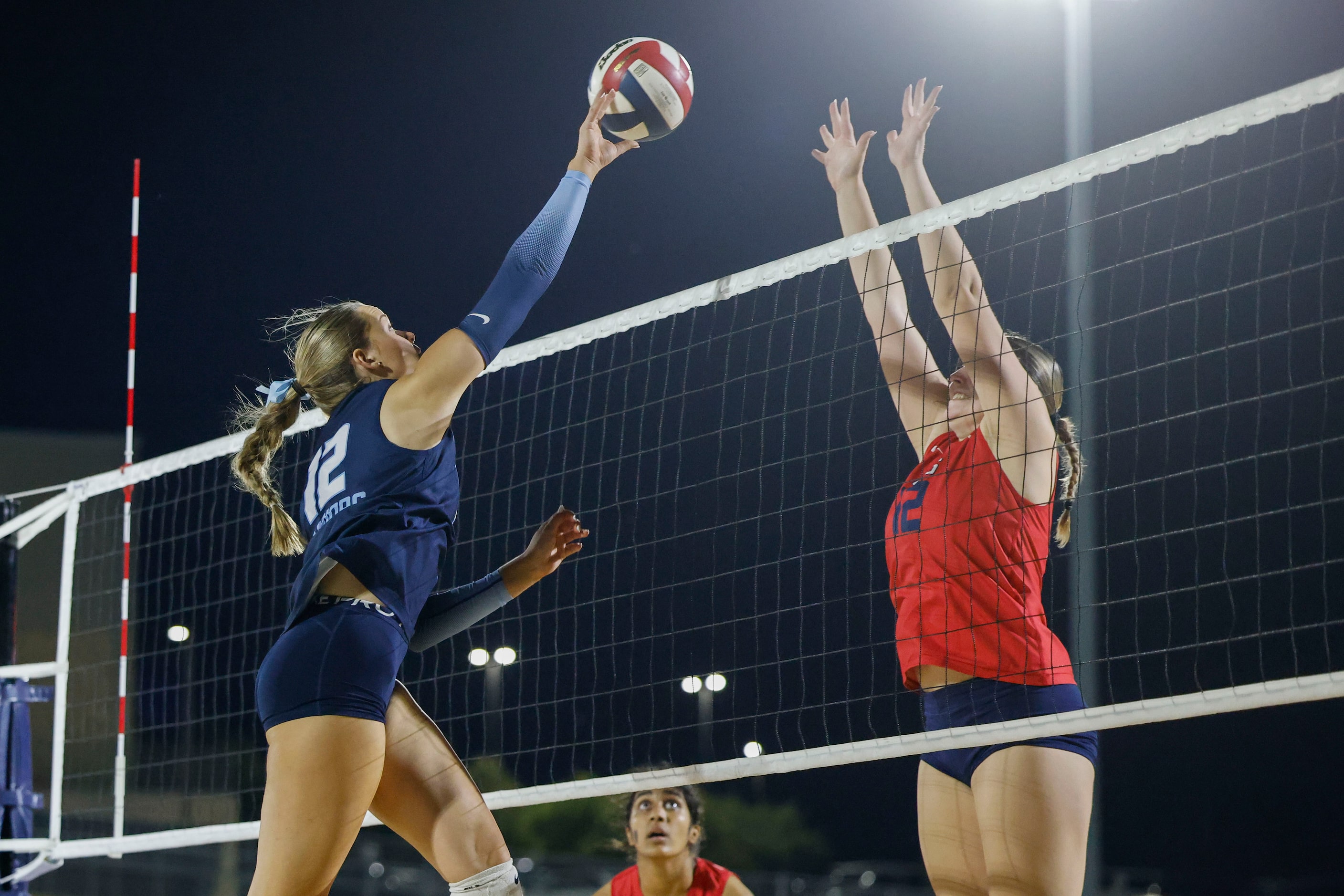 Liberty Christian School’s Emma Duninick (left) hits against  Grapevine High’s Sophie Baker...