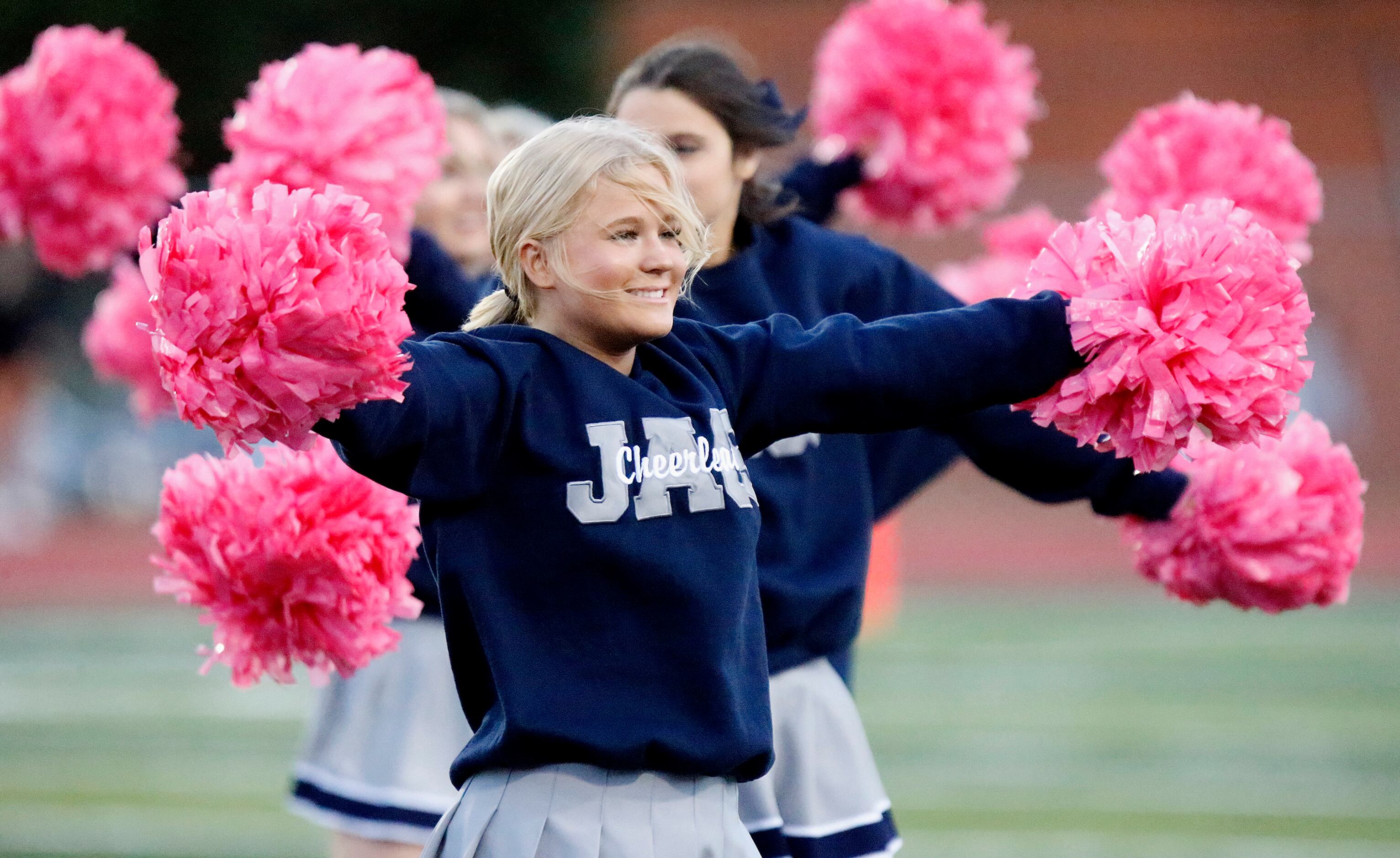 Flower Mound High School cheerleader Brynley Ballow, 17, performs a cheer before kickoff as...
