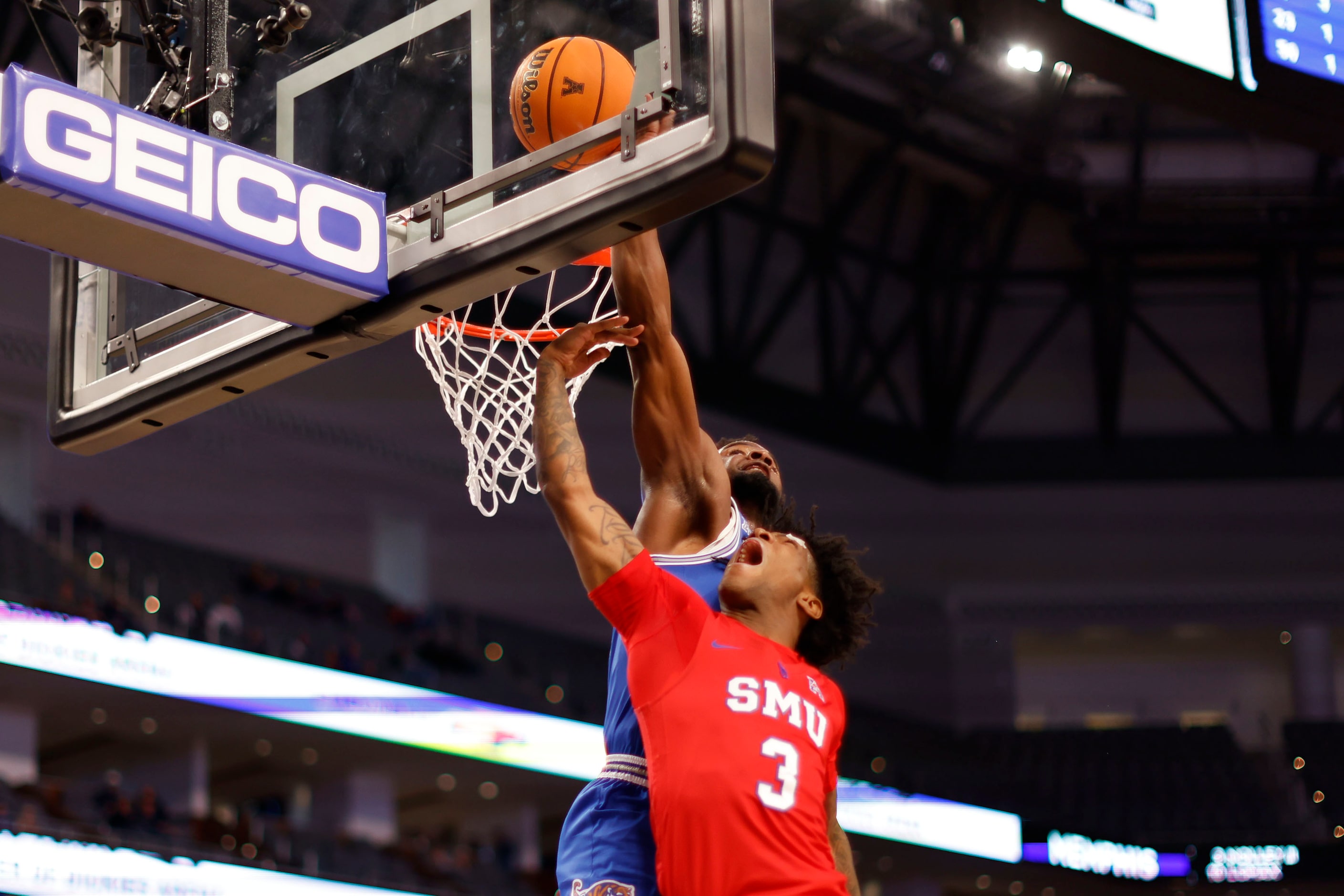 Memphis guard Alex Lomax (10) blocks a layup by SMU guard Kendric Davis (3) during the first...