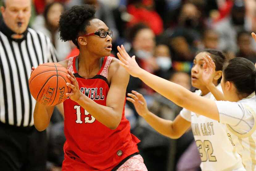 Denton Braswell High School forward Alisa Williams (15) looks to pass as she is defended by...
