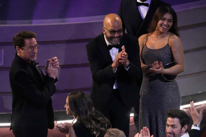 Robert Downey Jr., from left, Jeffrey Wright, and Juno Wright applaud Cord Jefferson on his...