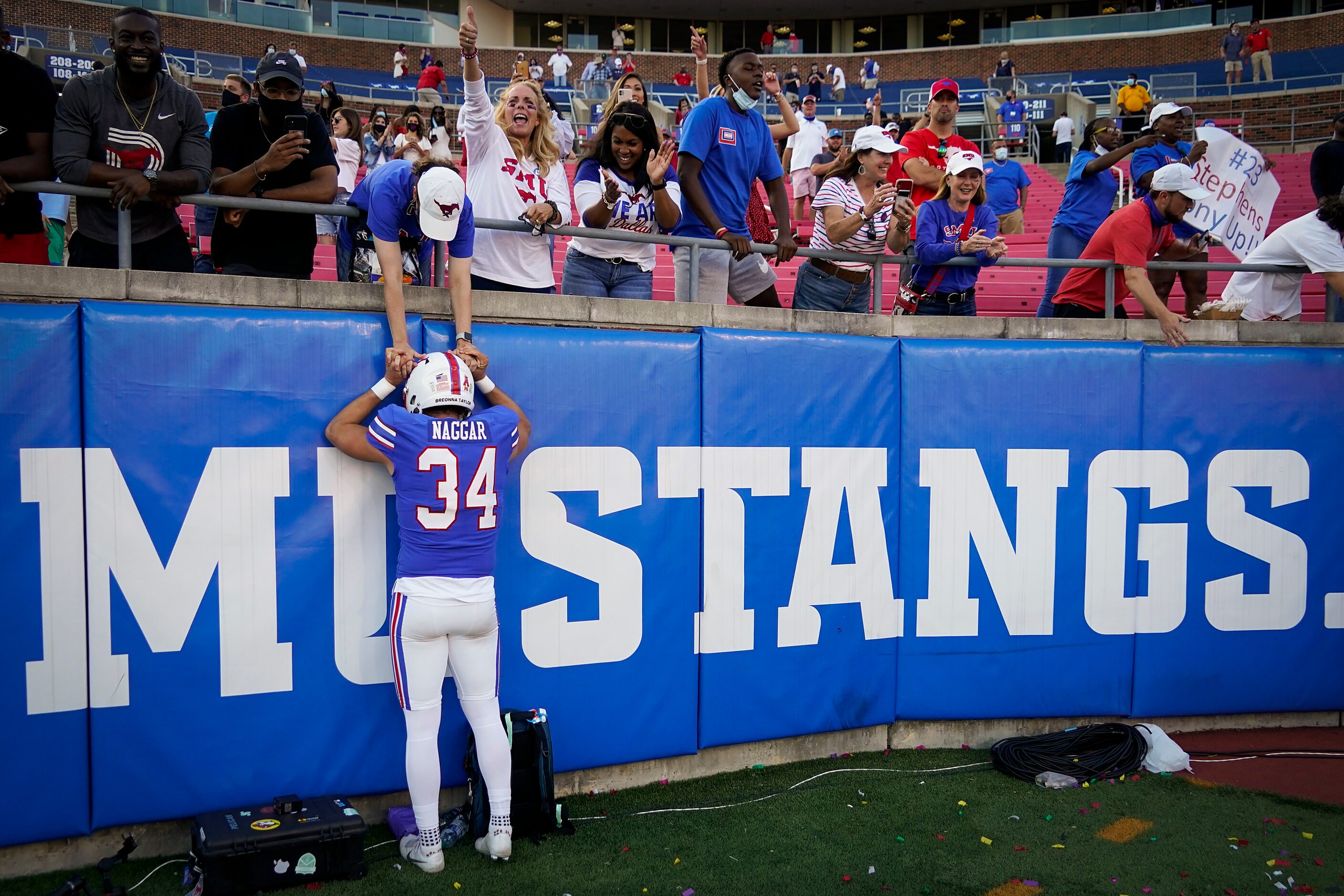 SMU place kicker Chris Naggar (34) celebrates with fans after hitting a 43-yard game-winning...