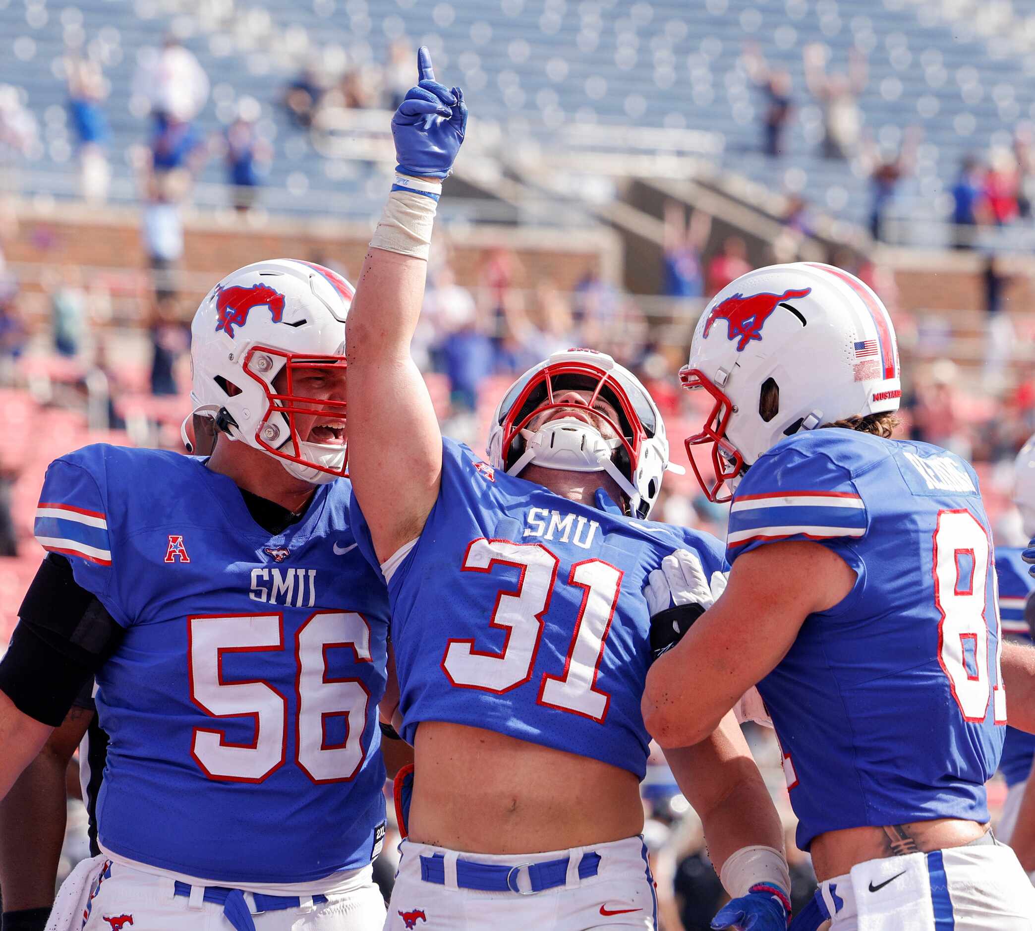 SMU running back Tyler Lavine (31) celebrates a touchdown with offensive lineman Branson...