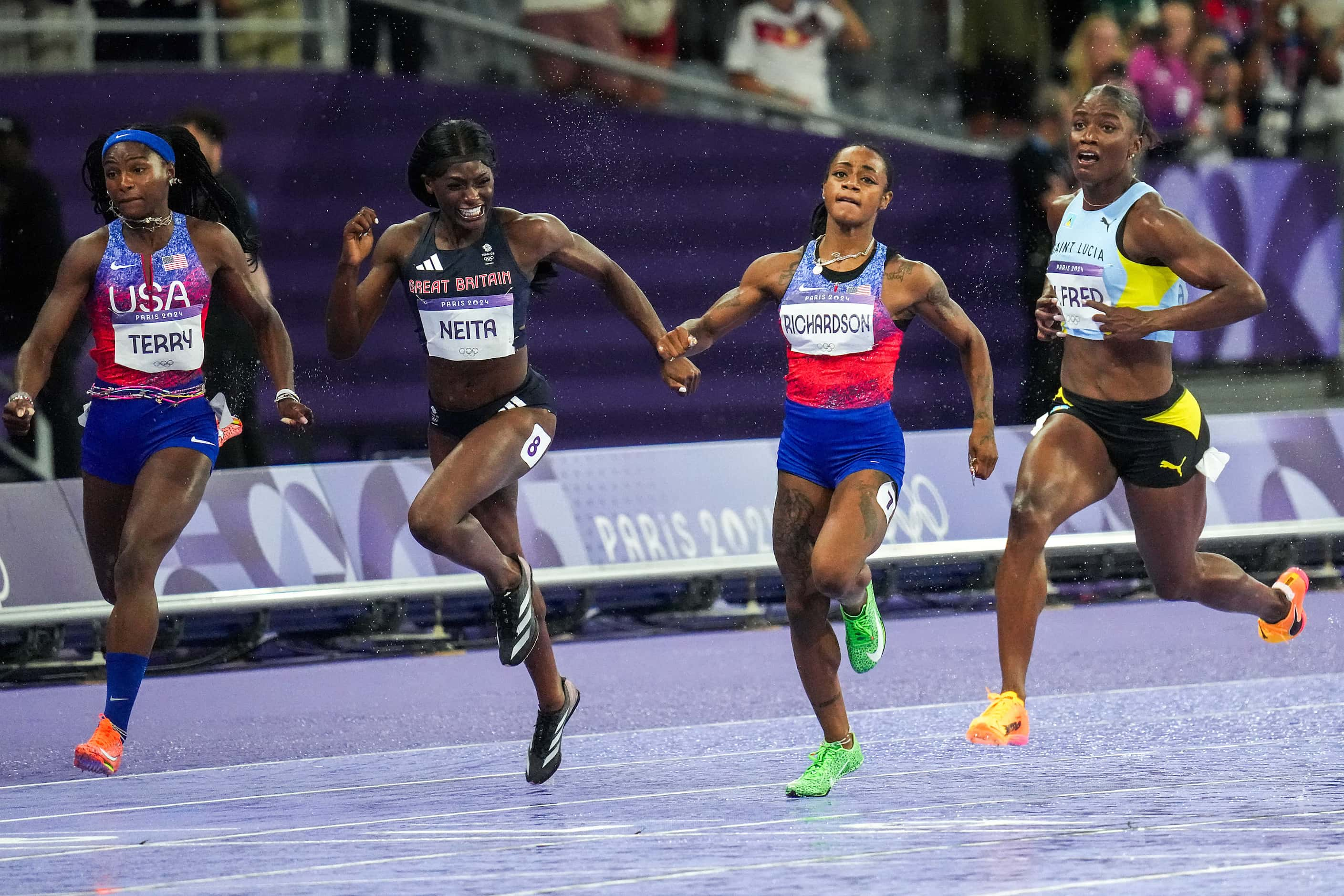 Gold medalist Julien Alfred of Saint Lucia celebrates as she finishes ahead of sliver...