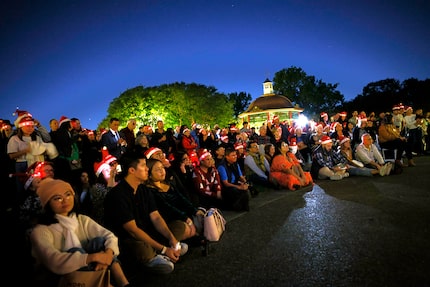 Visitors listen as members of the Turtle Creek Chorale sing at opening night of Holidays at...