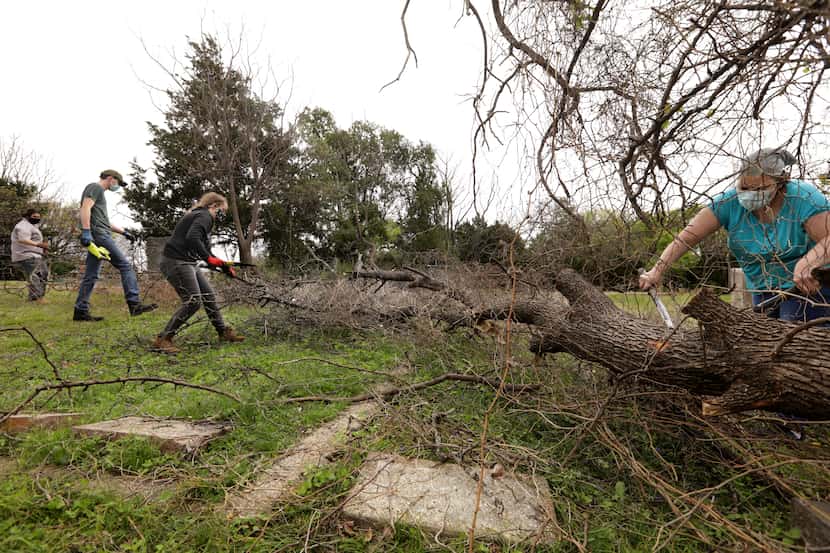 Volunteers clear away decades of overgrowth at Oak Cliff Cemetery on Apr. 3.