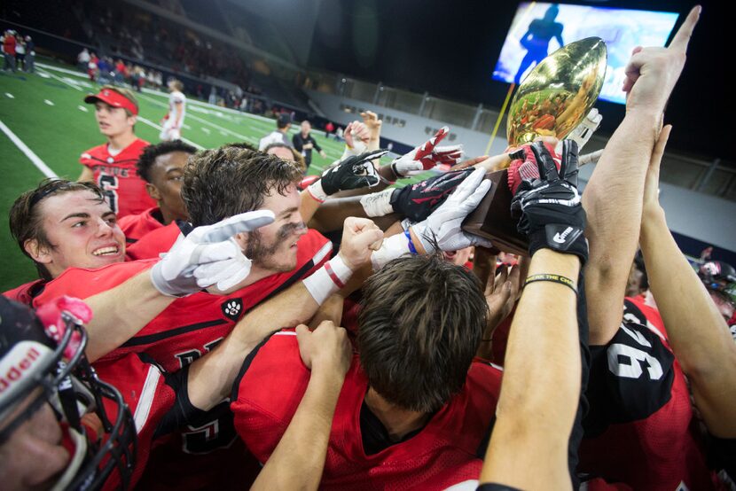 Heritage celebrates their 31-13 area round playoff victory over Justin Northwest on Nov. 19,...