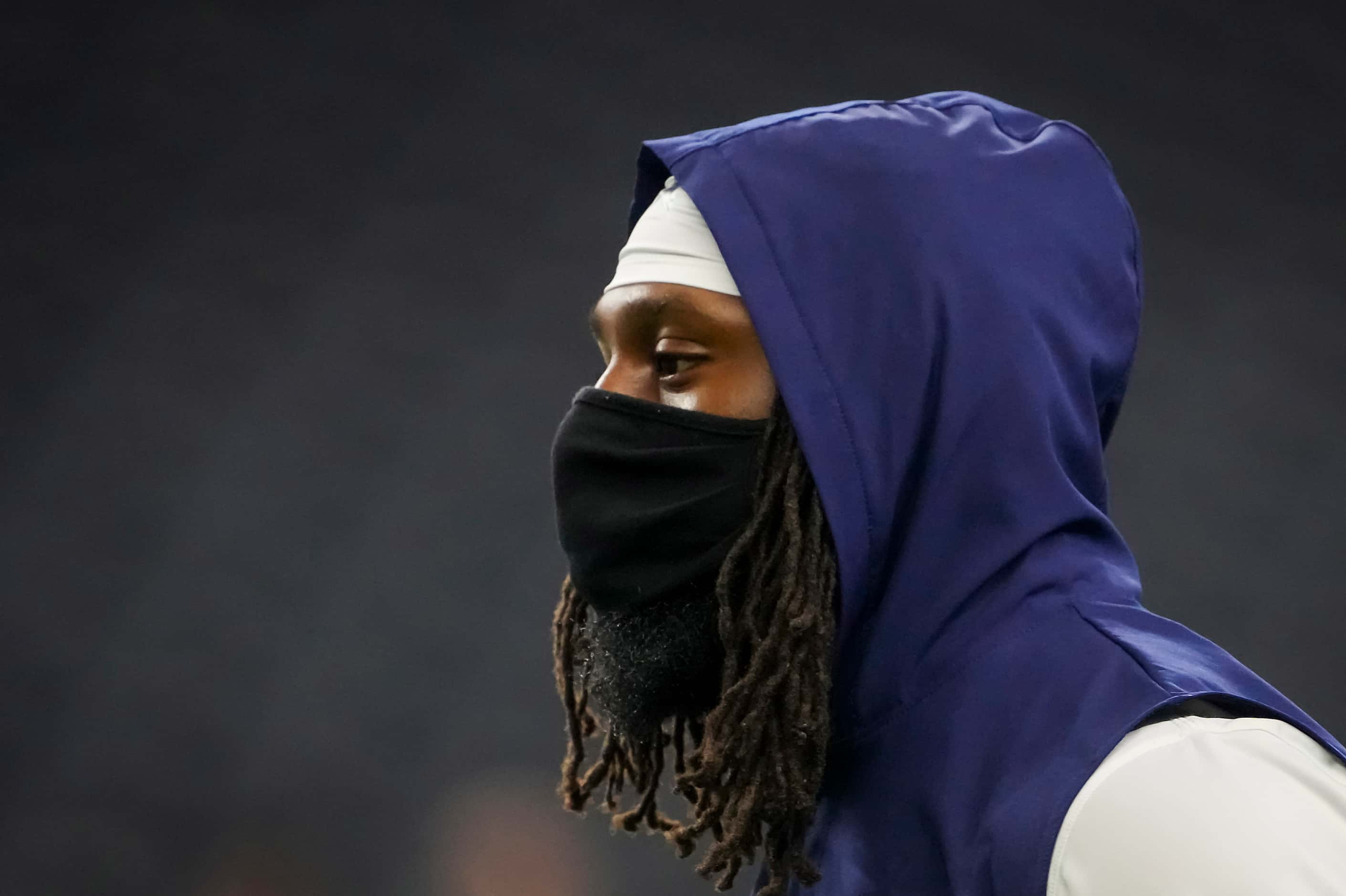 Dallas Cowboy safety Malik Hooker wears a face mask as he warm up before a preseason NFL...