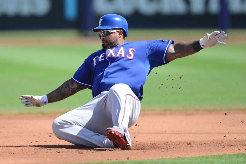 Texas Rangers first baseman Prince Fielder (84) slides at second base as he attempts a...
