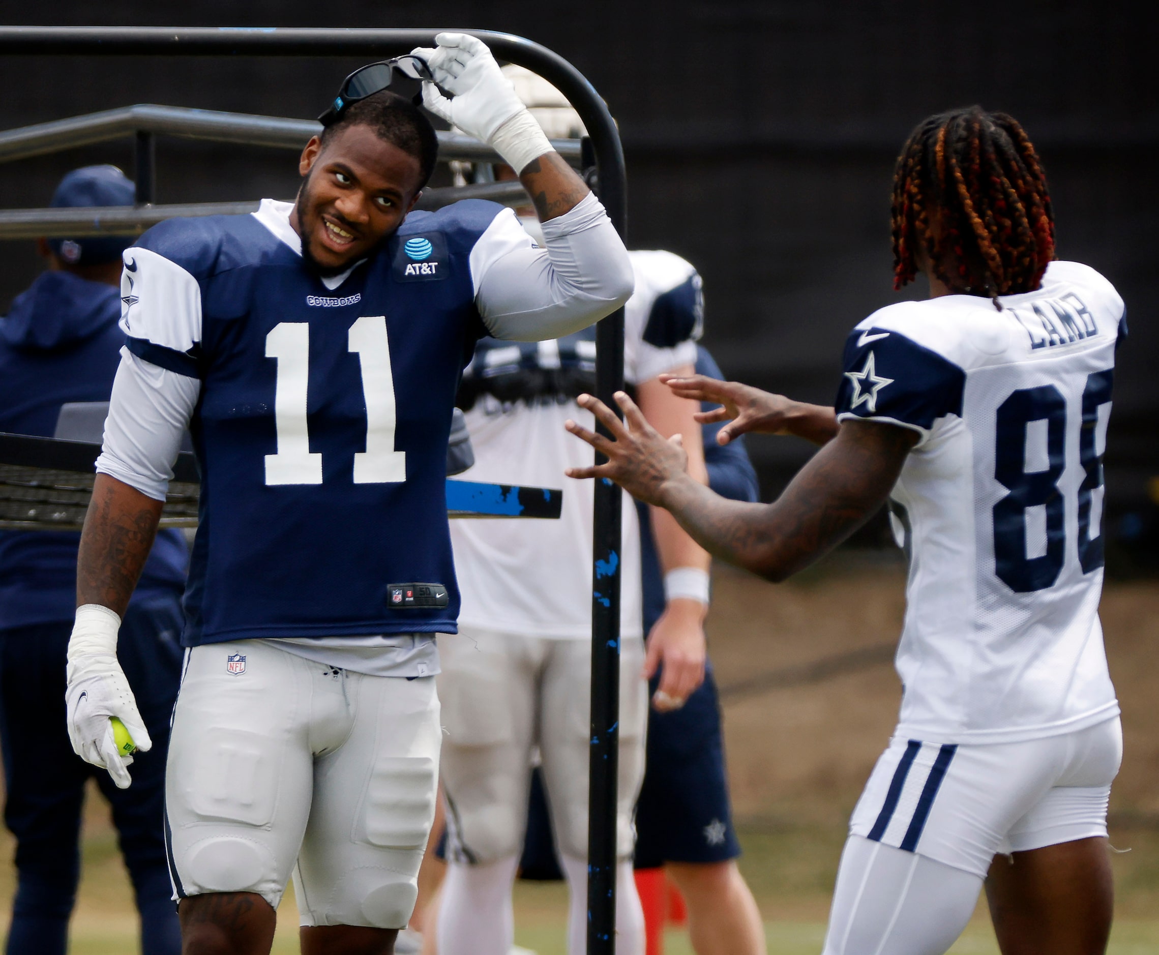 Dallas Cowboys outside linebacker Micah Parsons (11) laughs with wide receiver CeeDee Lamb...