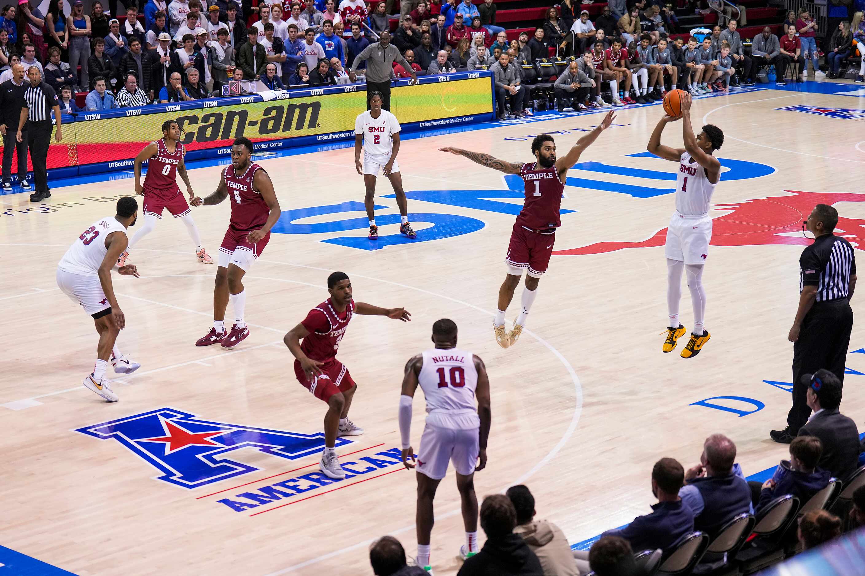 SMU guard Zhuric Phelps shoots over Temple guard Damian Dunn across the American Athletic...