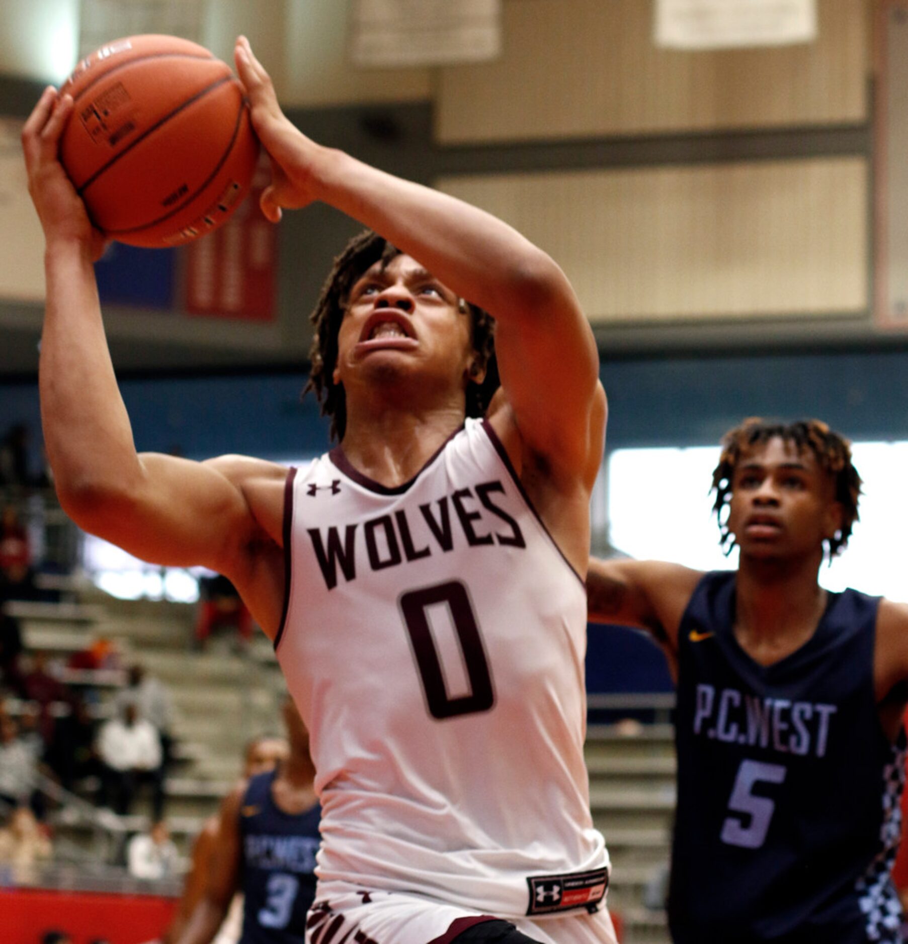 Mansfield Timberview senior Joey Marimba (0) drives hard to the basket as Putnam City West,...