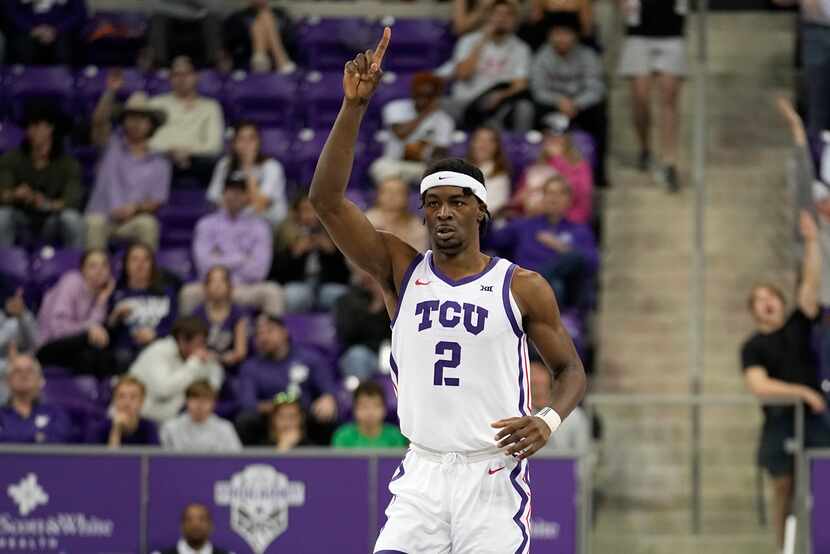 TCU forward Emanuel Miller (2) celebrates sinking a three-point shot in the second half of...