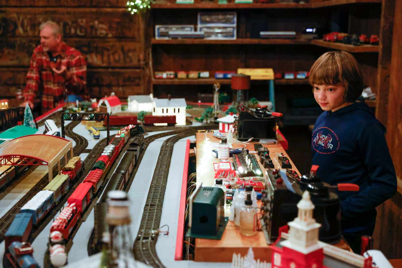 Garrett Clark, 11, watches as he operates the vintage toy train exhibit at Old City Park in...