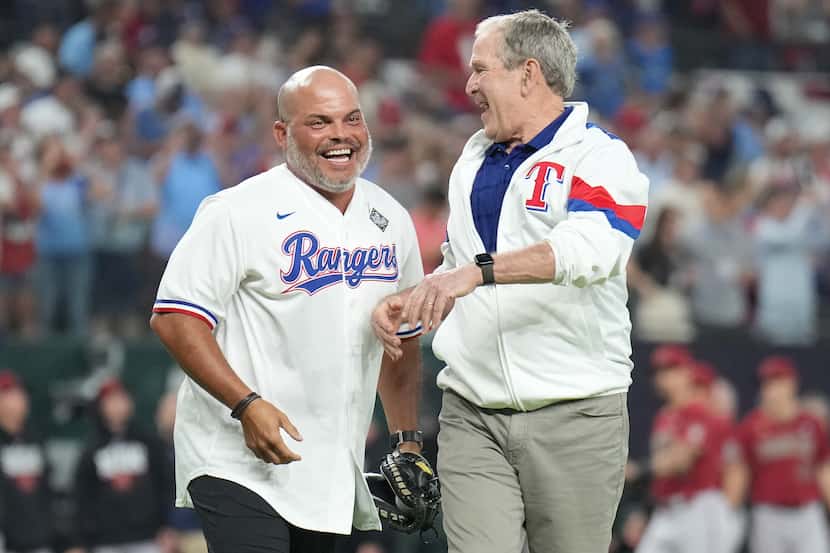 Former President George W. Bush, right, laughs with former Texas Rangers catcher Iván...