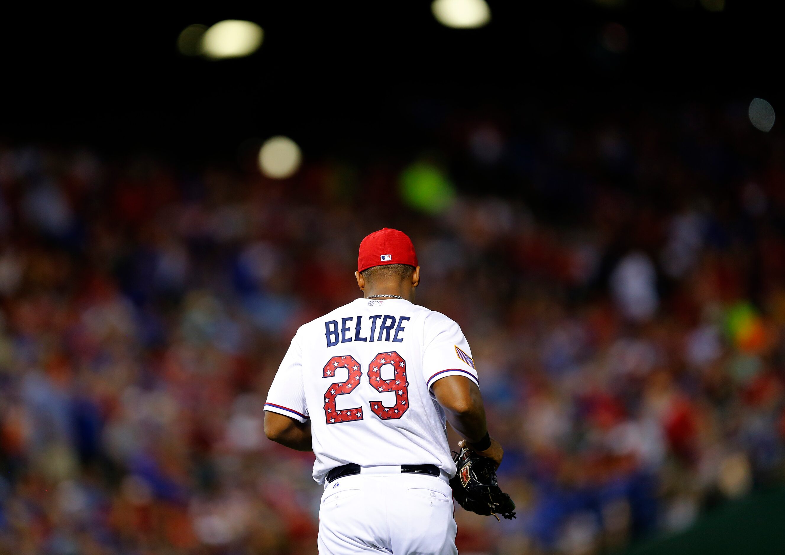 Sporting patriotic stars on his number 29, Texas Rangers third baseman Adrian Beltre head to...