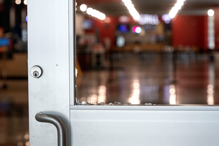 Shards of glass cling to a door frame just inside the west entrance to the Duncanville...