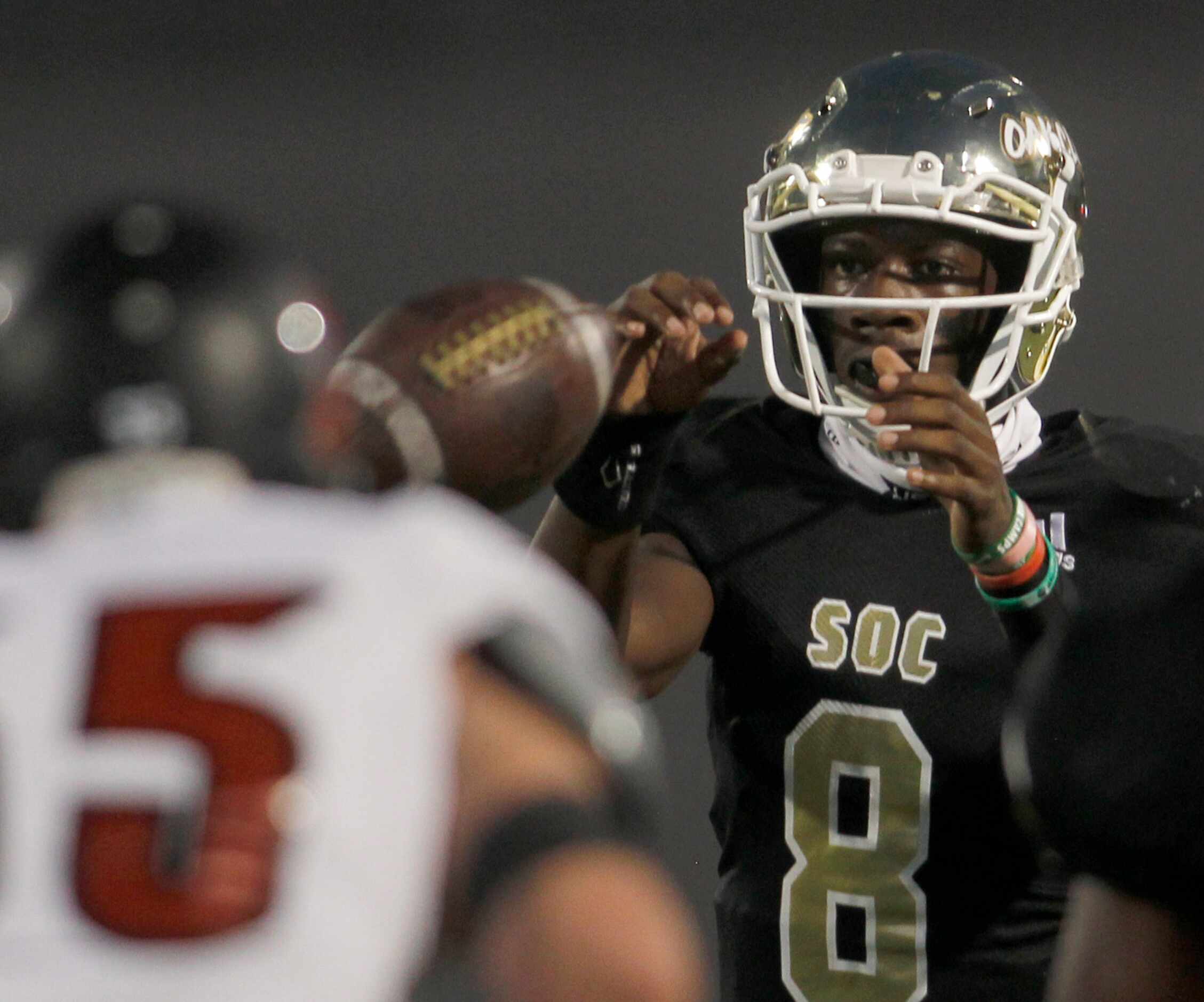 South Oak Cliff quarterback Kevin Henry-Jennings (8) takes the snap from center during first...