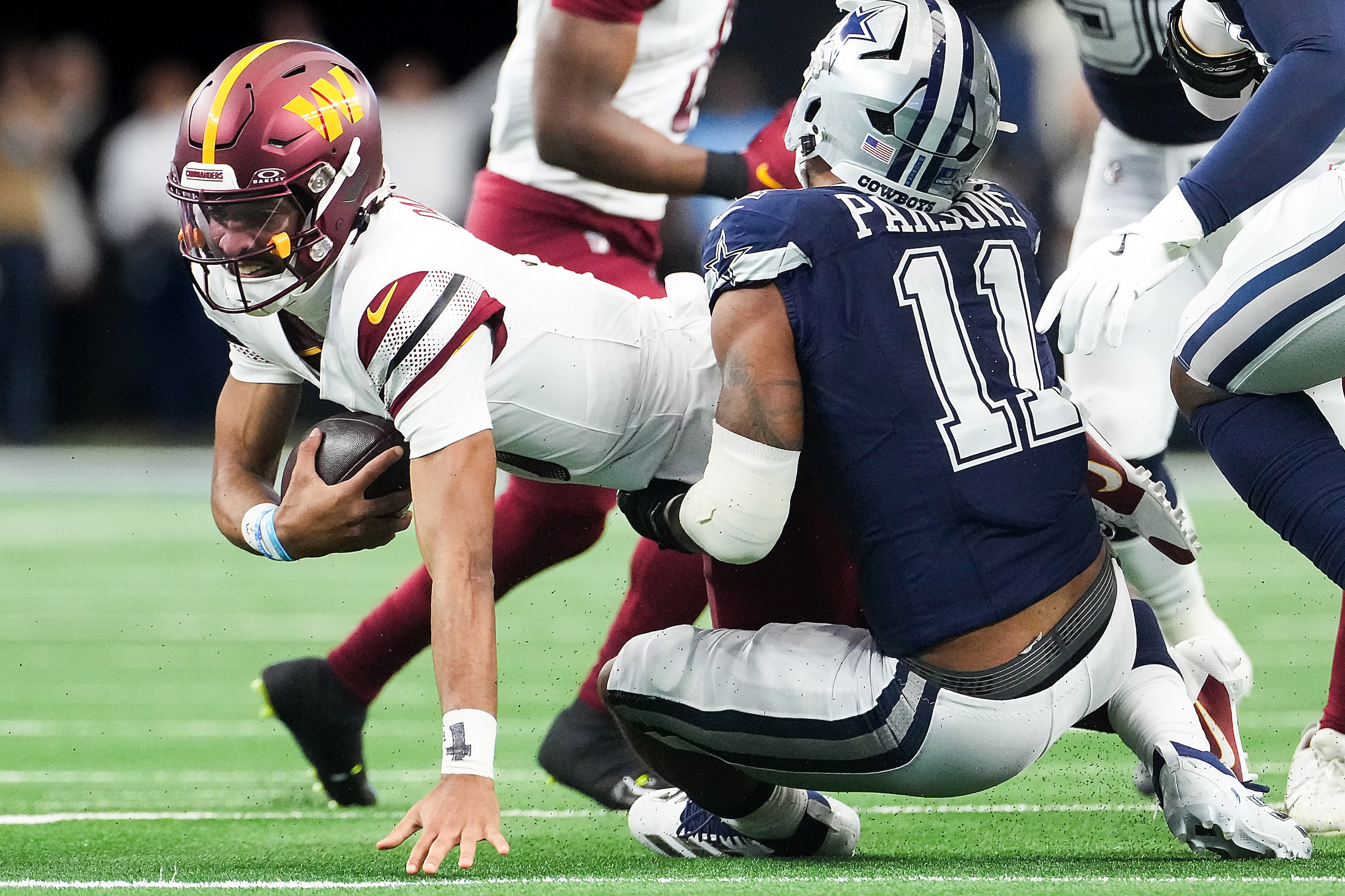 Dallas Cowboys linebacker Micah Parsons (11) sacks Washington Commanders quarterback Jayden...