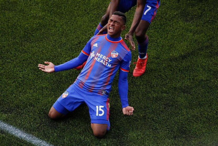 FC Cincinnati midfielder Allan Cruz (15) reacts with forward Roland Lamah (7), above, after...