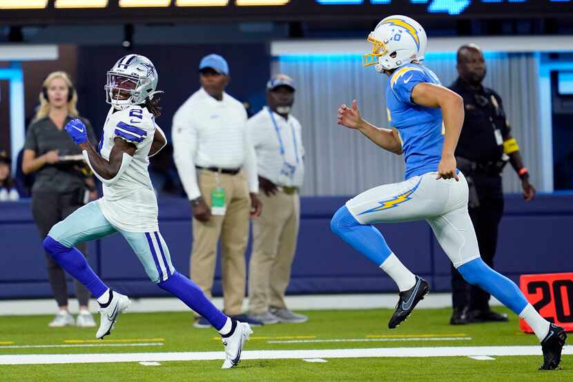 Dallas Cowboys' KaVontae Turpin, left, returns a punt for a touchdown past Los Angeles...