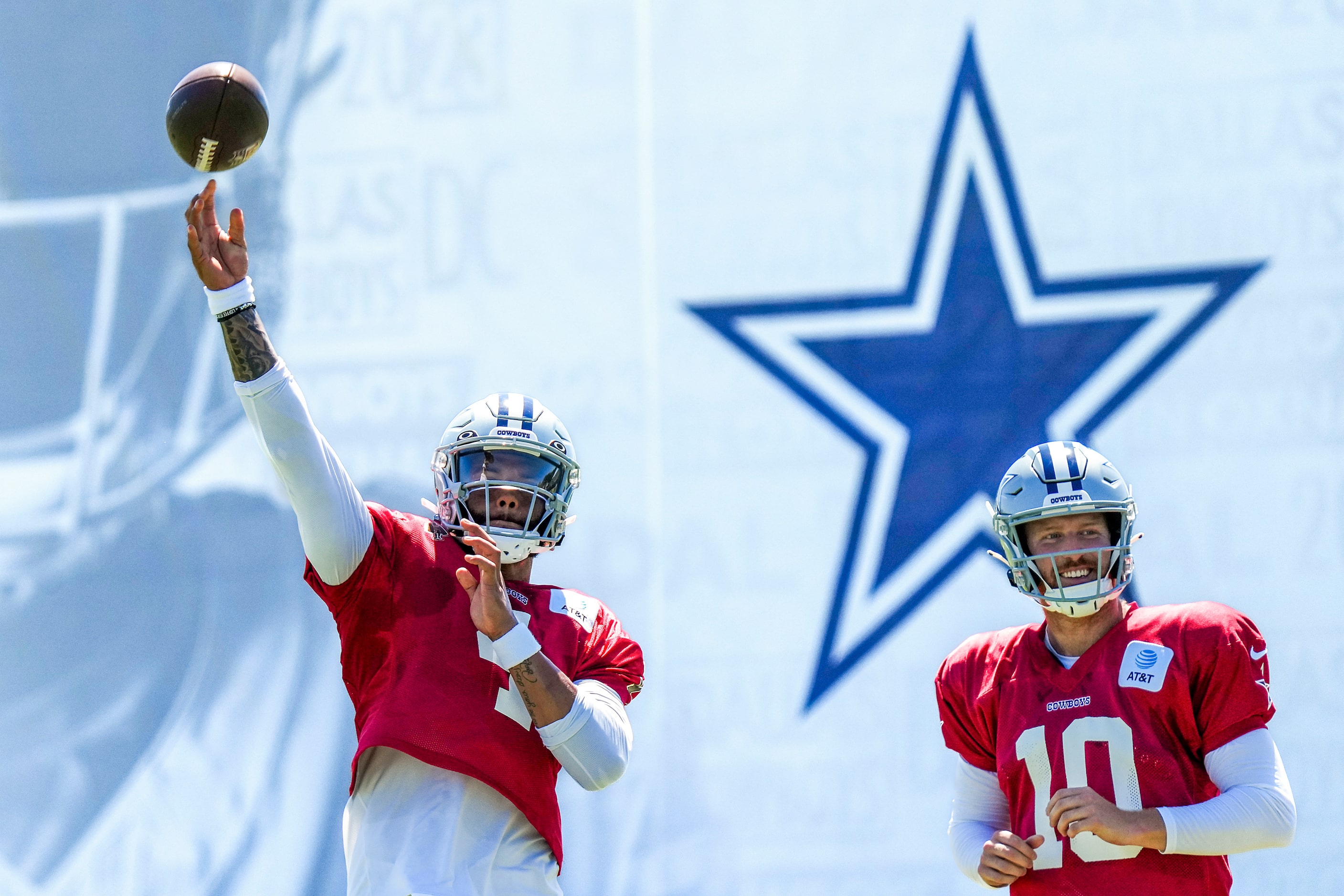 Dallas Cowboys quarterback Dak Prescott (4) throws a pass as quarterback Cooper Rush (10)...