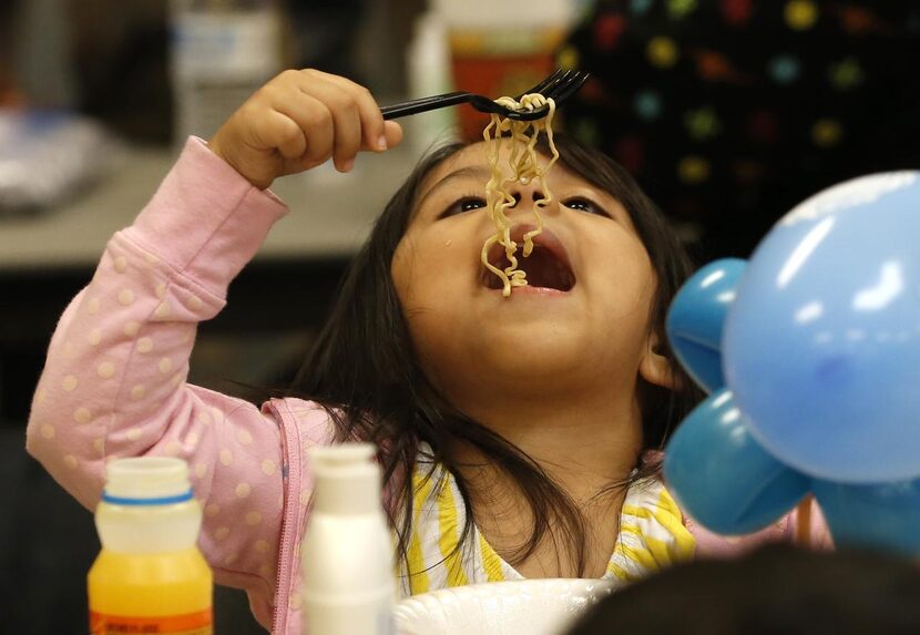 Instant noodles  and other donated foods are on the menu for Tamiya Nuñez, 4, at the Garland...