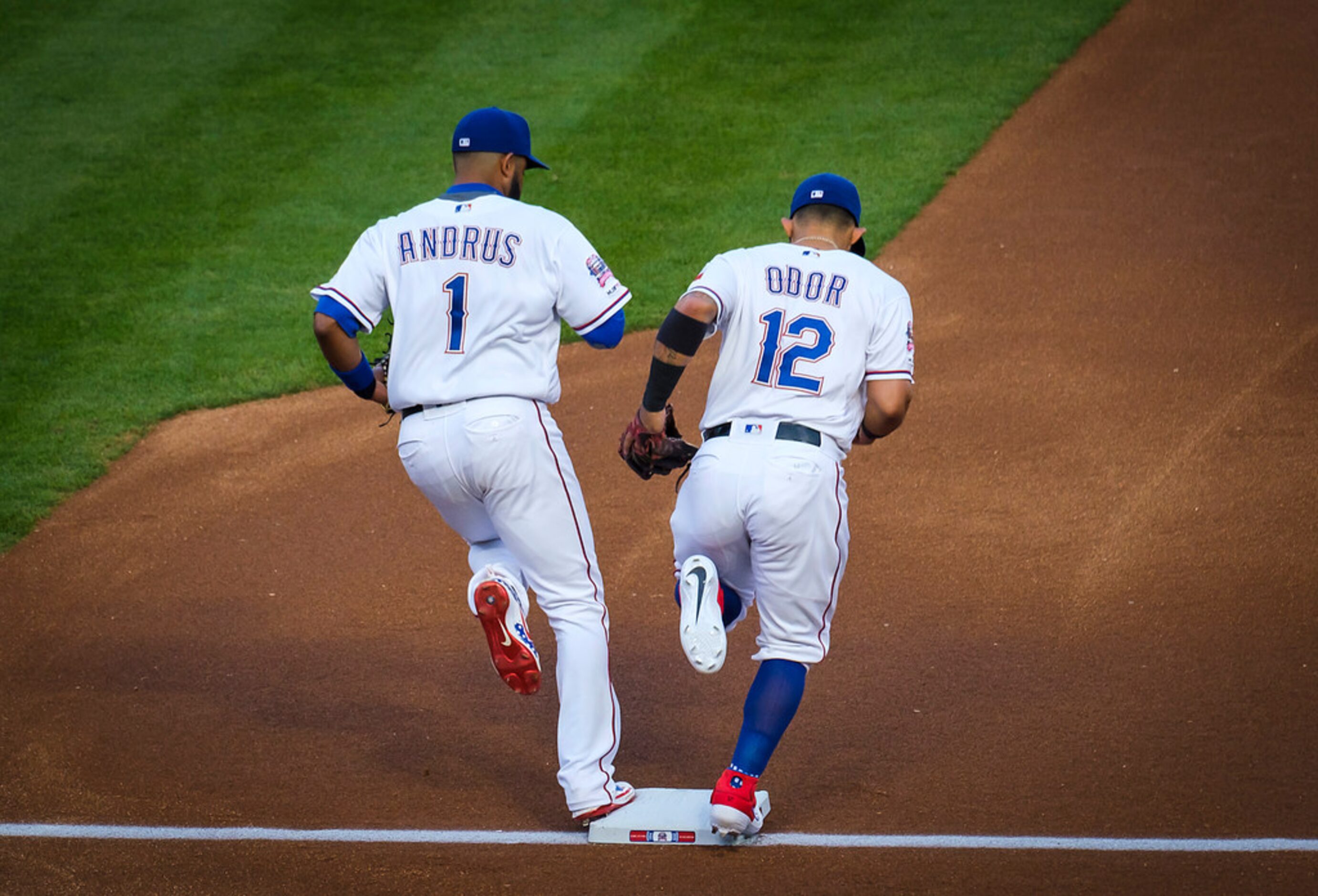 Texas Rangers shortstop Elvis Andrus and second baseman Rougned Odor take the field before a...