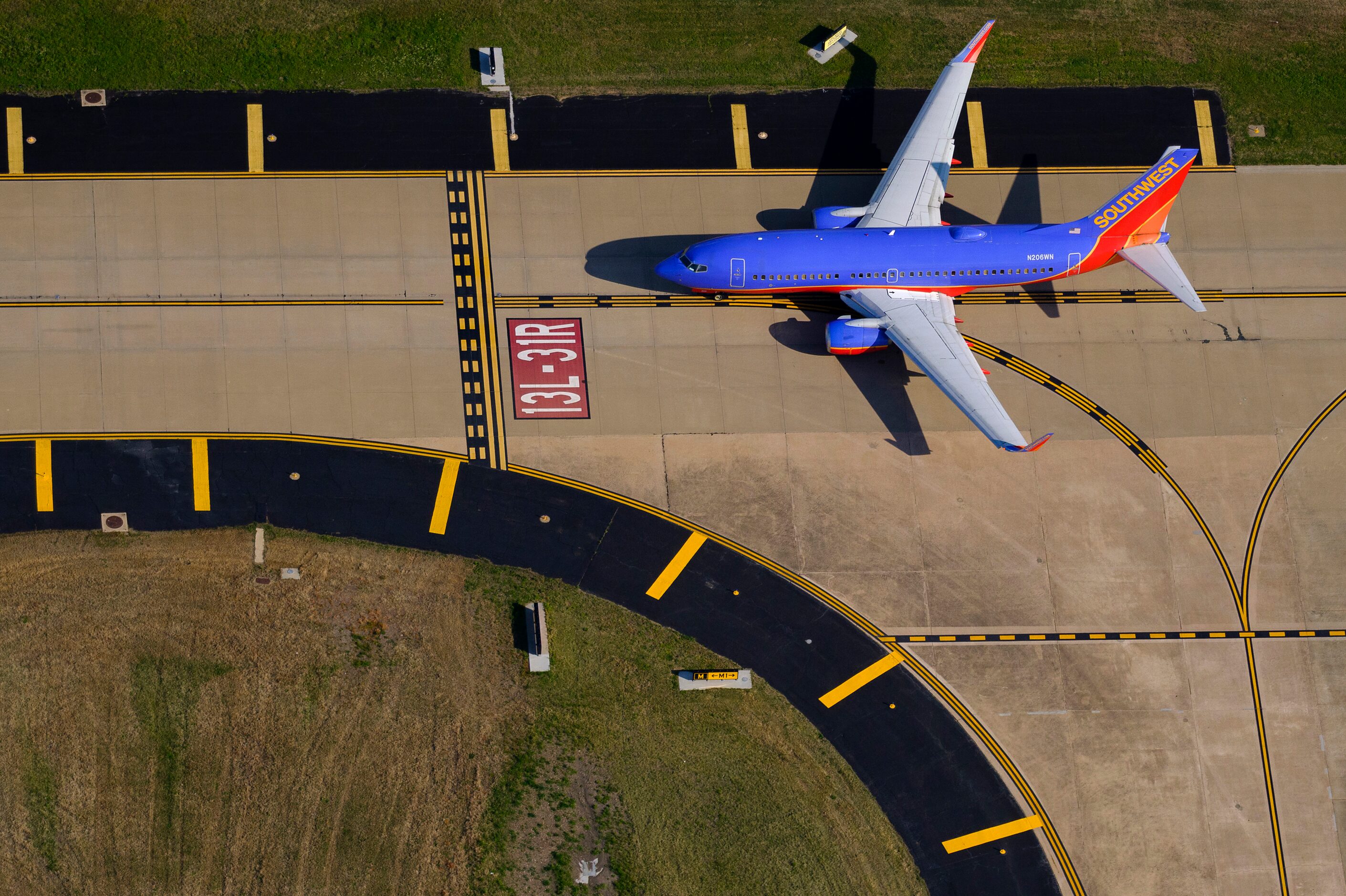 A Southwest Airlines 737-7H4 holds short of the runway at Dallas Love Field.