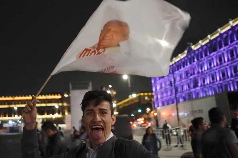 Un simpatizante del candidato ganador Andrés Manuel López Obrador celebra en el zócalo de la...