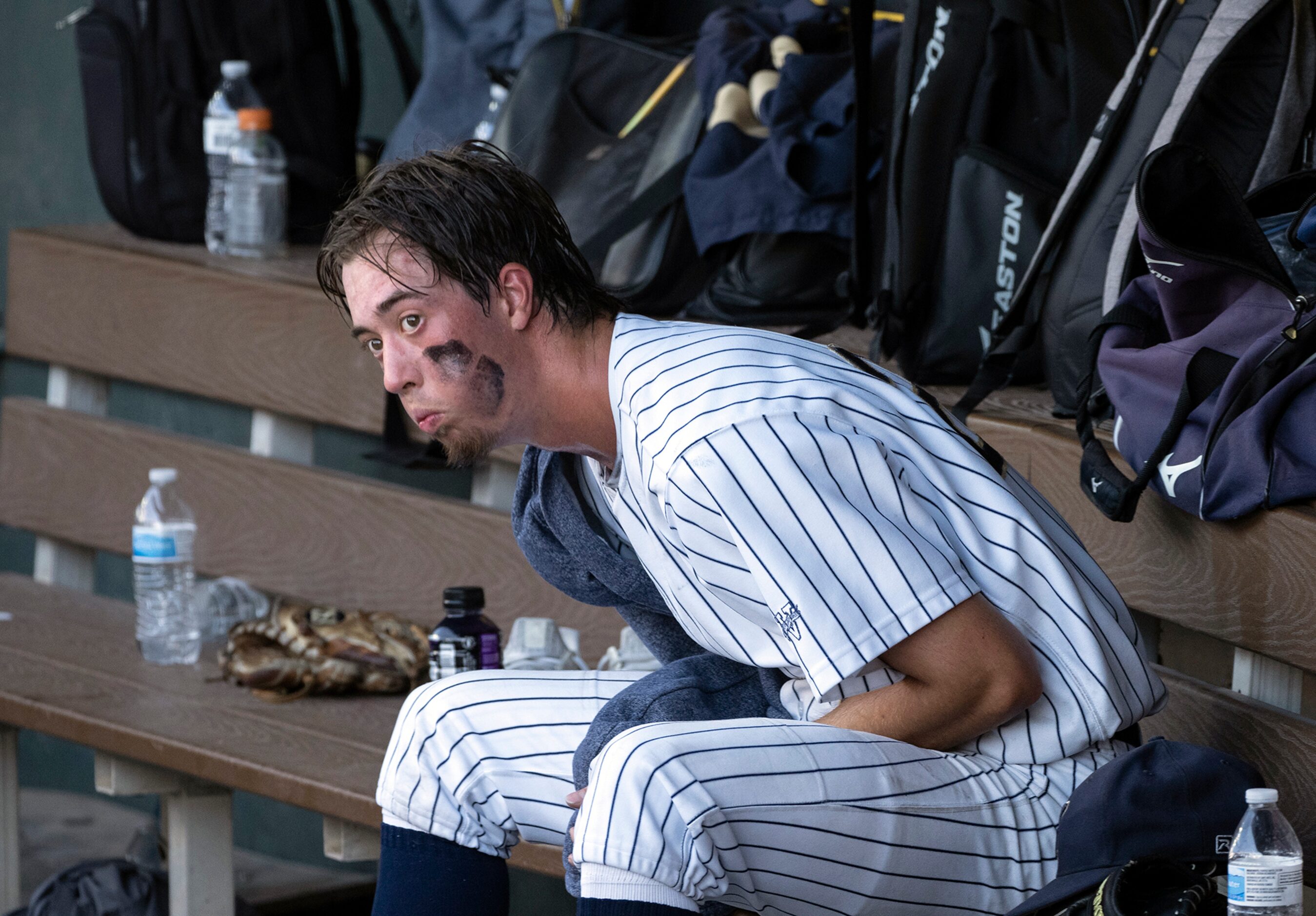 Keller Eric Hammond, (27), rests in the dugout between innings against Houston Strake Jesuit...