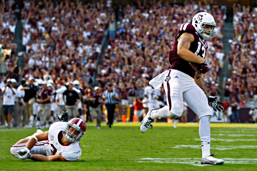 Texas A&M Aggies wide receiver Mike Evans (13) stays ahead of Alabama Crimson Tide defensive...
