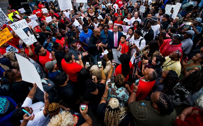 Frederick Douglass Haynes III talks to protesters during a protest Monday  over the shooting...