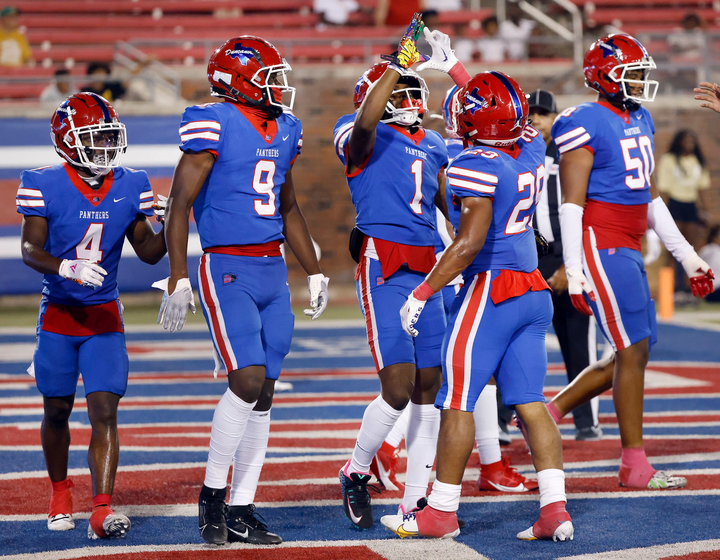 Duncanville wide receiver Dakorien Moore (1) is congratulated on his first quarter touchdown...