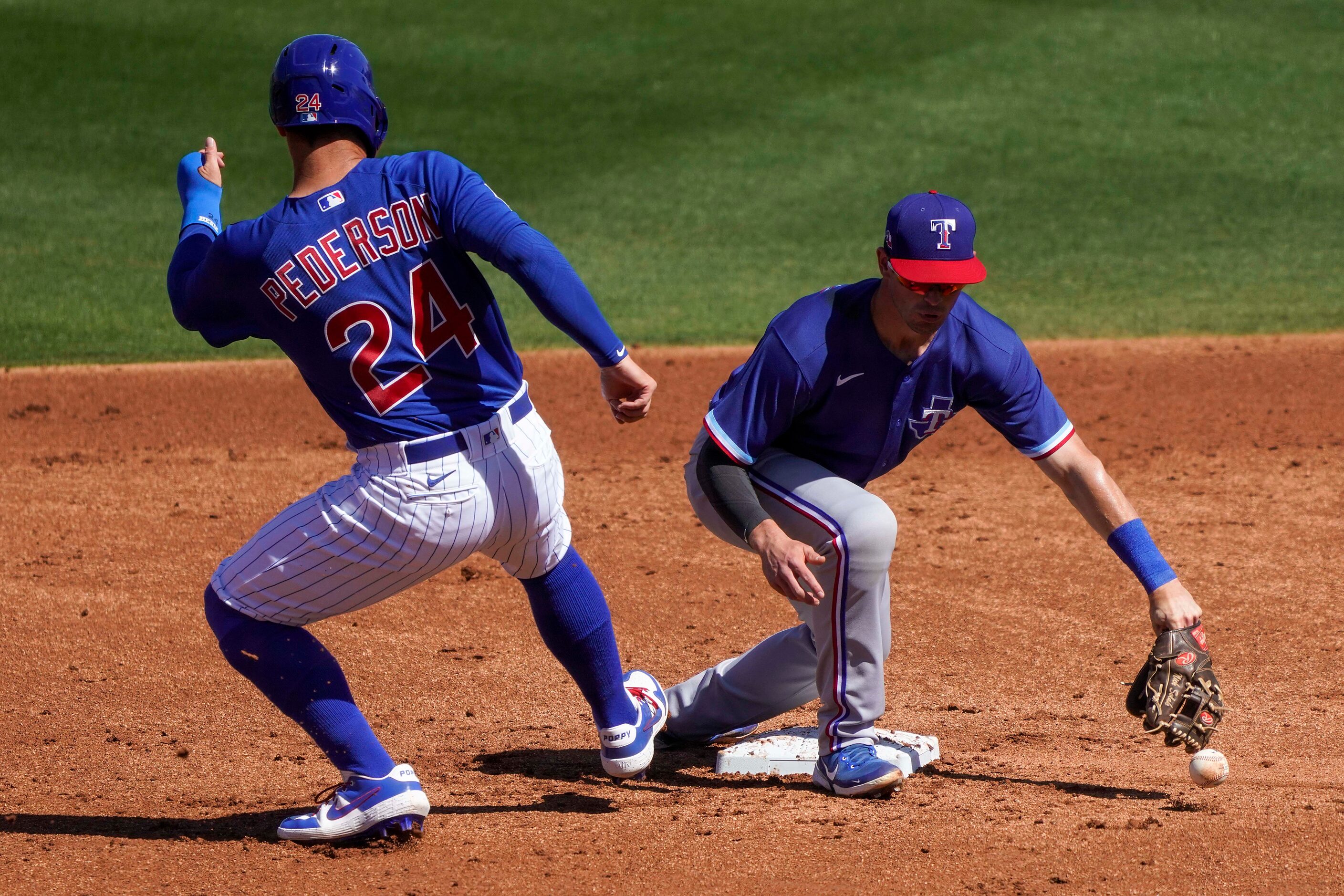 Chicago Cubs left fielder Joc Pederson gets is safe at second base as the ball gets past...