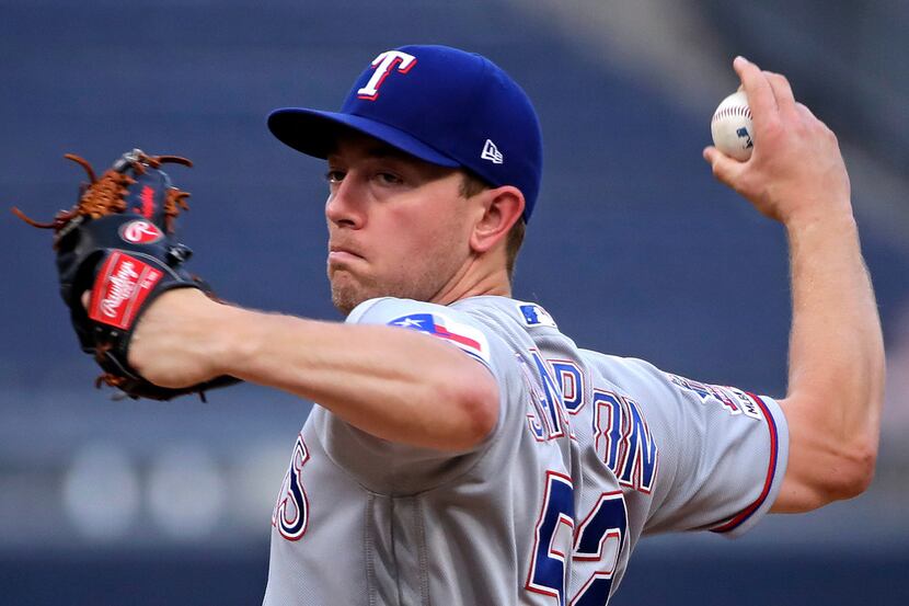 Texas Rangers starting pitcher Adrian Sampson delivers during the first inning of a baseball...