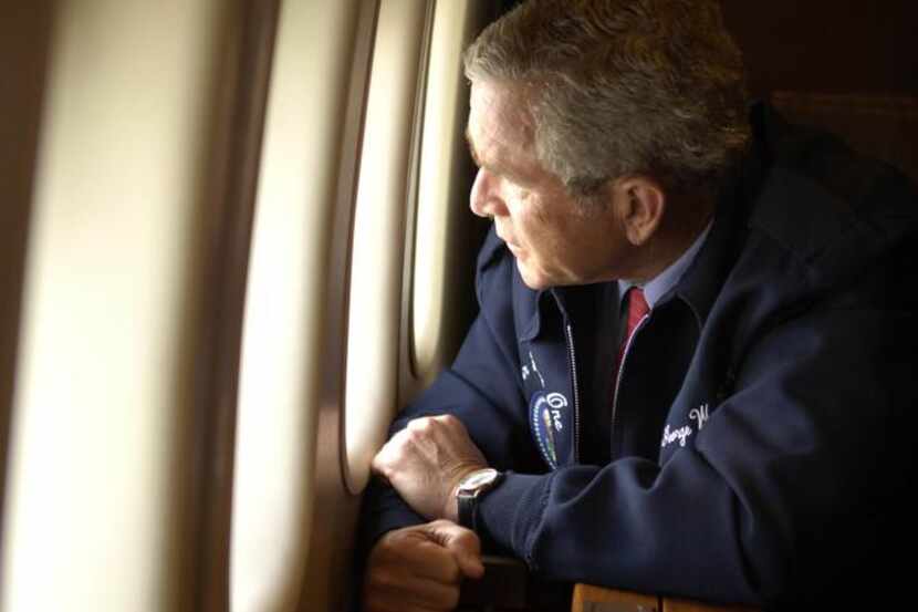 
The image of President George W. Bush peering through the window of Air Force One on a...